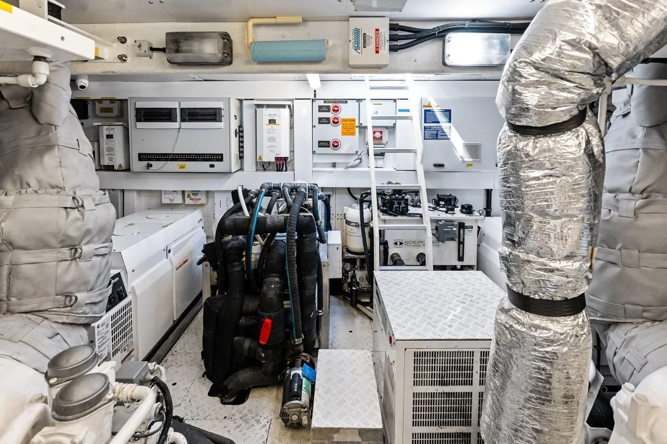 The engine room is meticulously organized, showcasing advanced machinery and equipment. aboard IT'S ENOUGH Yacht for Sale