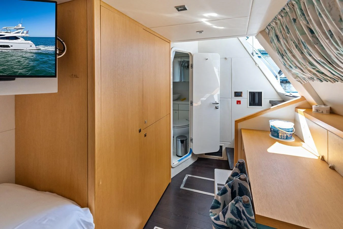 The cozy crew quarters feature practical storage and a private bathroom. aboard IT'S ENOUGH Yacht for Sale