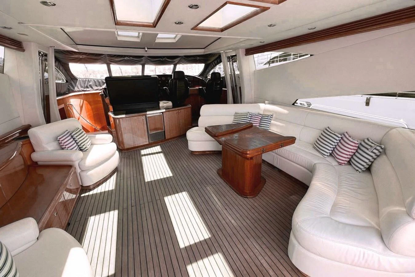 The yacht's interior features a spacious and elegant salon with ample seating and natural light. aboard TIMELESS C Yacht for Sale