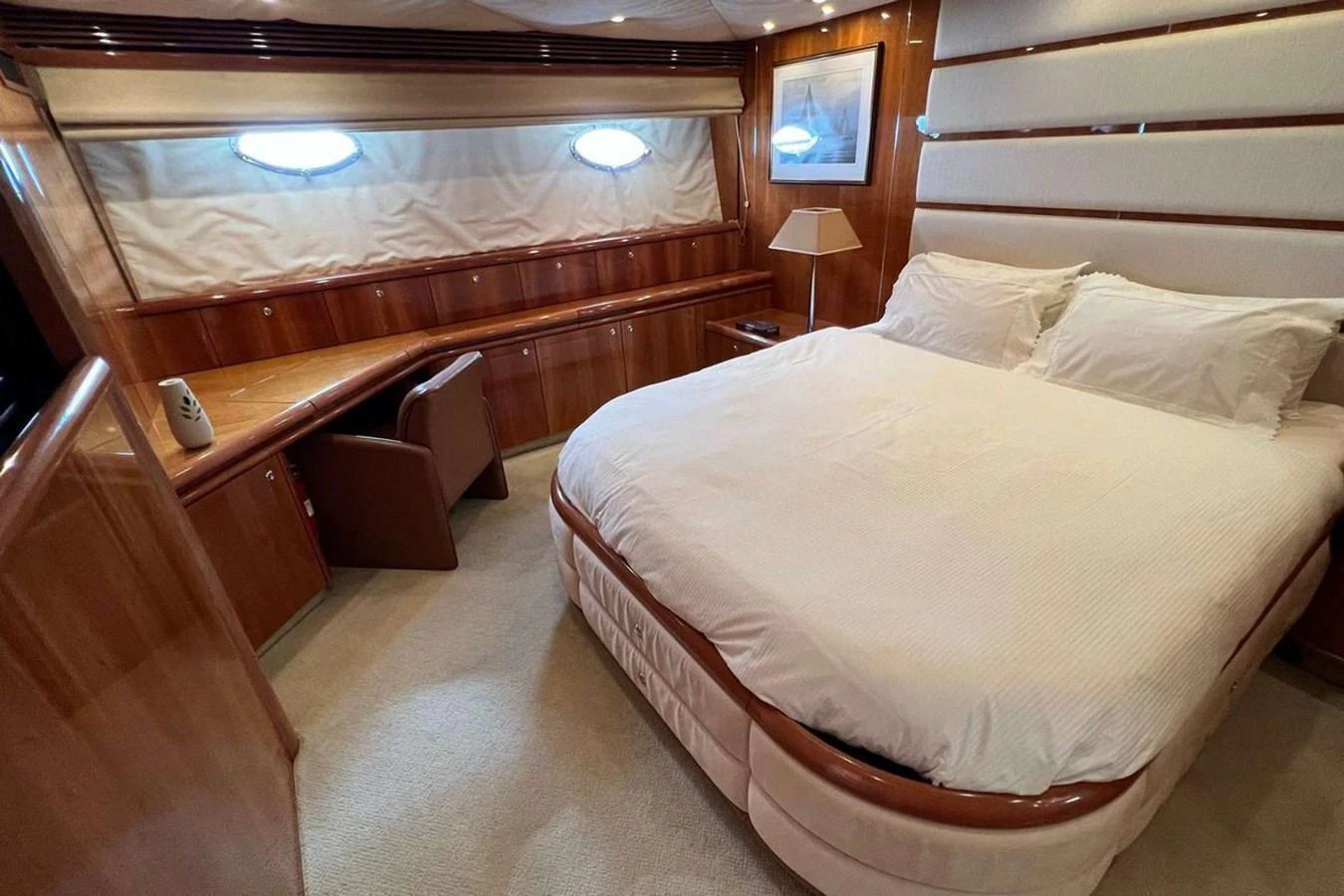 A luxurious stateroom featuring a comfortable bed and elegant wooden finishes. aboard TIMELESS C Yacht for Sale