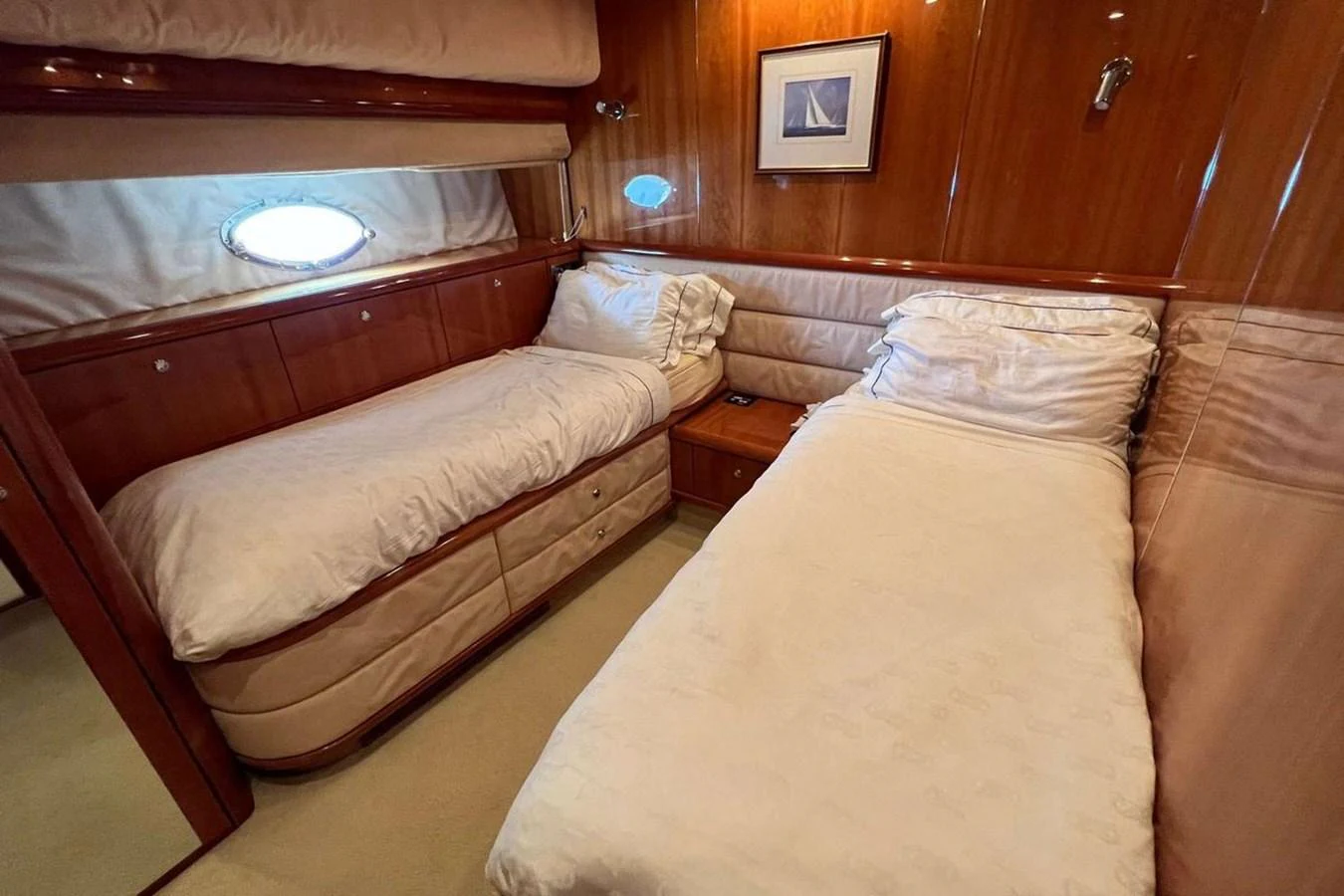 The twin stateroom features two comfortable single beds with elegant wood paneling and soft lighting. aboard TIMELESS C Yacht for Sale