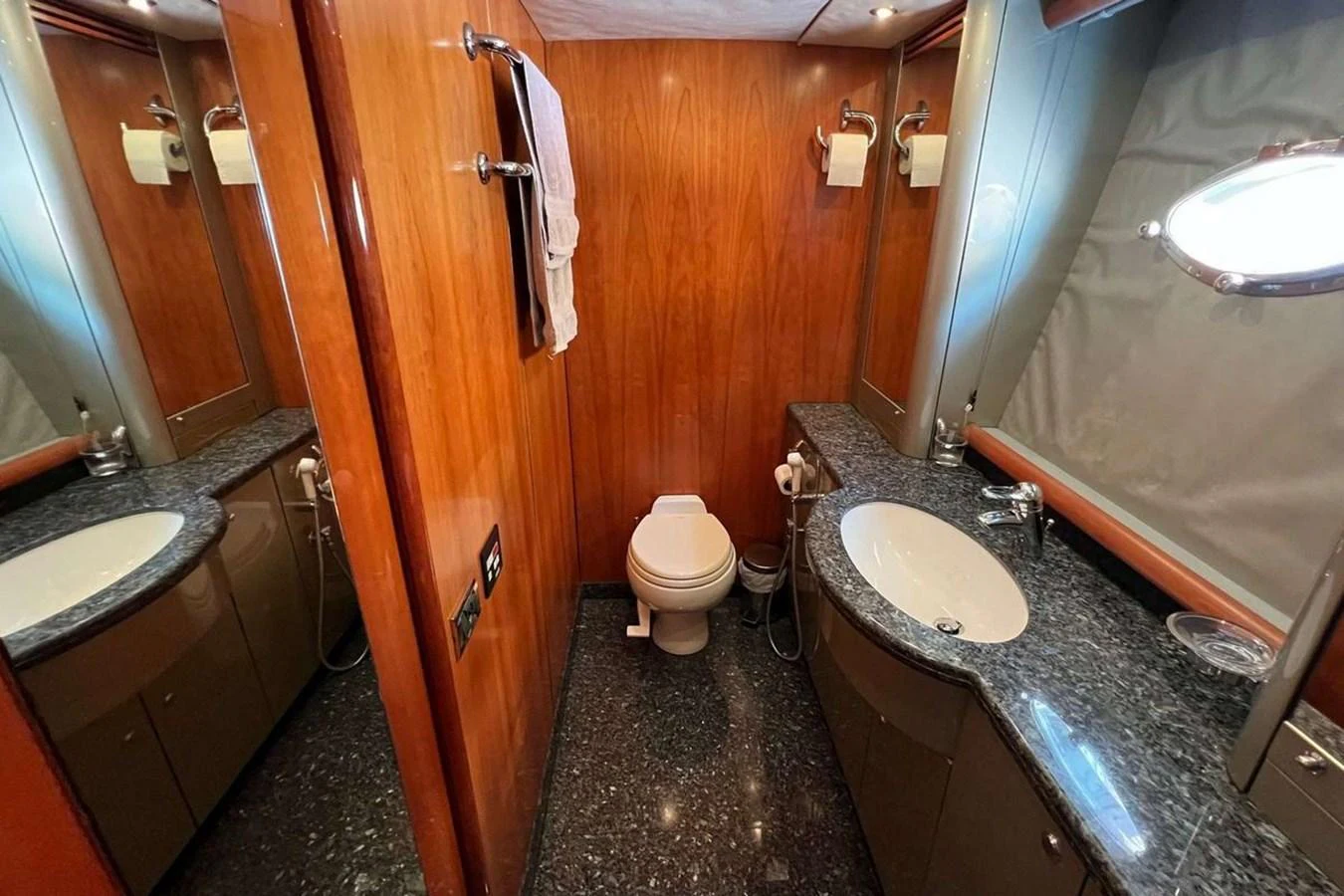 The yacht's bathroom features elegant wood paneling and sleek granite countertops. aboard TIMELESS C Yacht for Sale