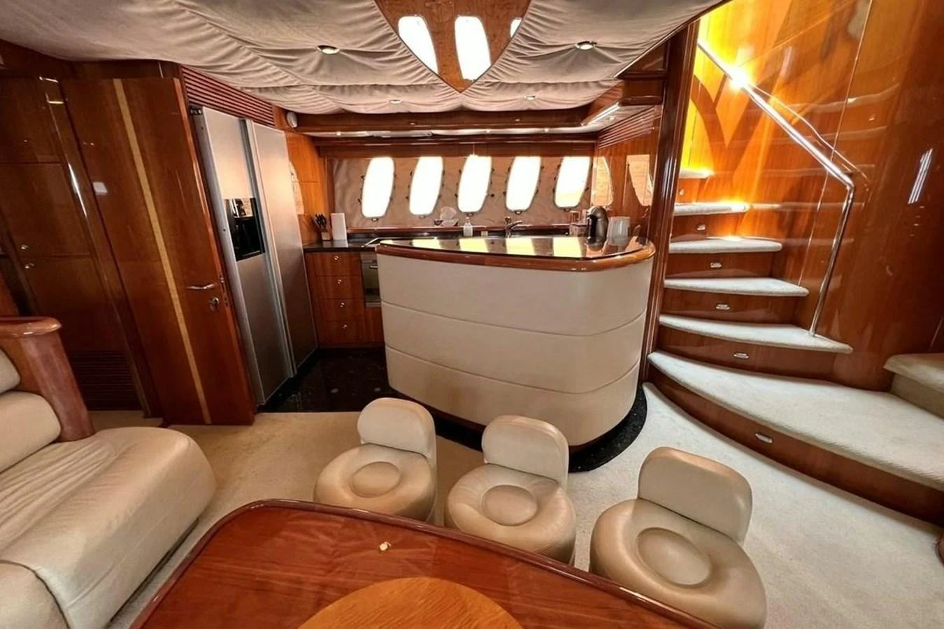 The yacht's galley features a modern design with luxurious finishes and ample seating. aboard TIMELESS C Yacht for Sale