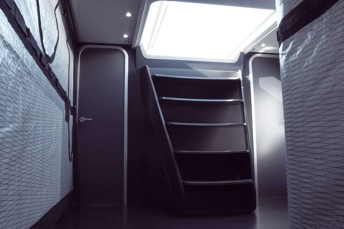 A modern yacht interior featuring a staircase and sleek design elements. aboard BULLITT Yacht for Sale