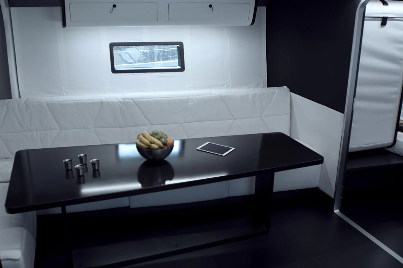 A sleek and modern dining area with a black table and white seating. aboard BULLITT Yacht for Sale
