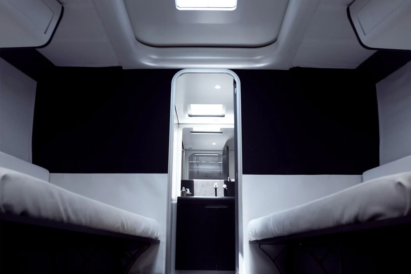 A sleek and modern interior cabin with a view into the galley area. aboard BULLITT Yacht for Sale