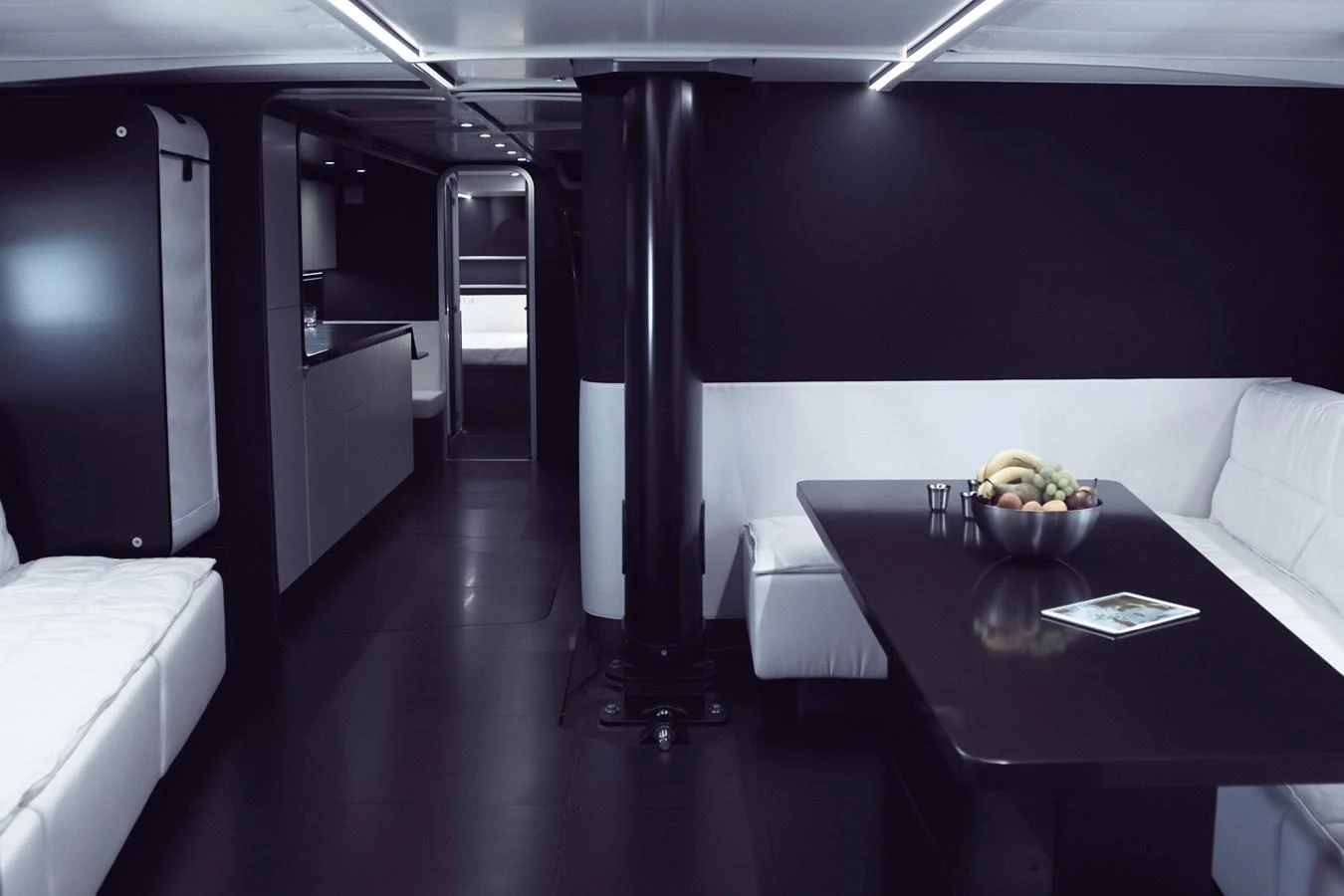 The yacht's interior features a sleek, modern design with a dining area and a cozy seating arrangement. aboard BULLITT Yacht for Sale