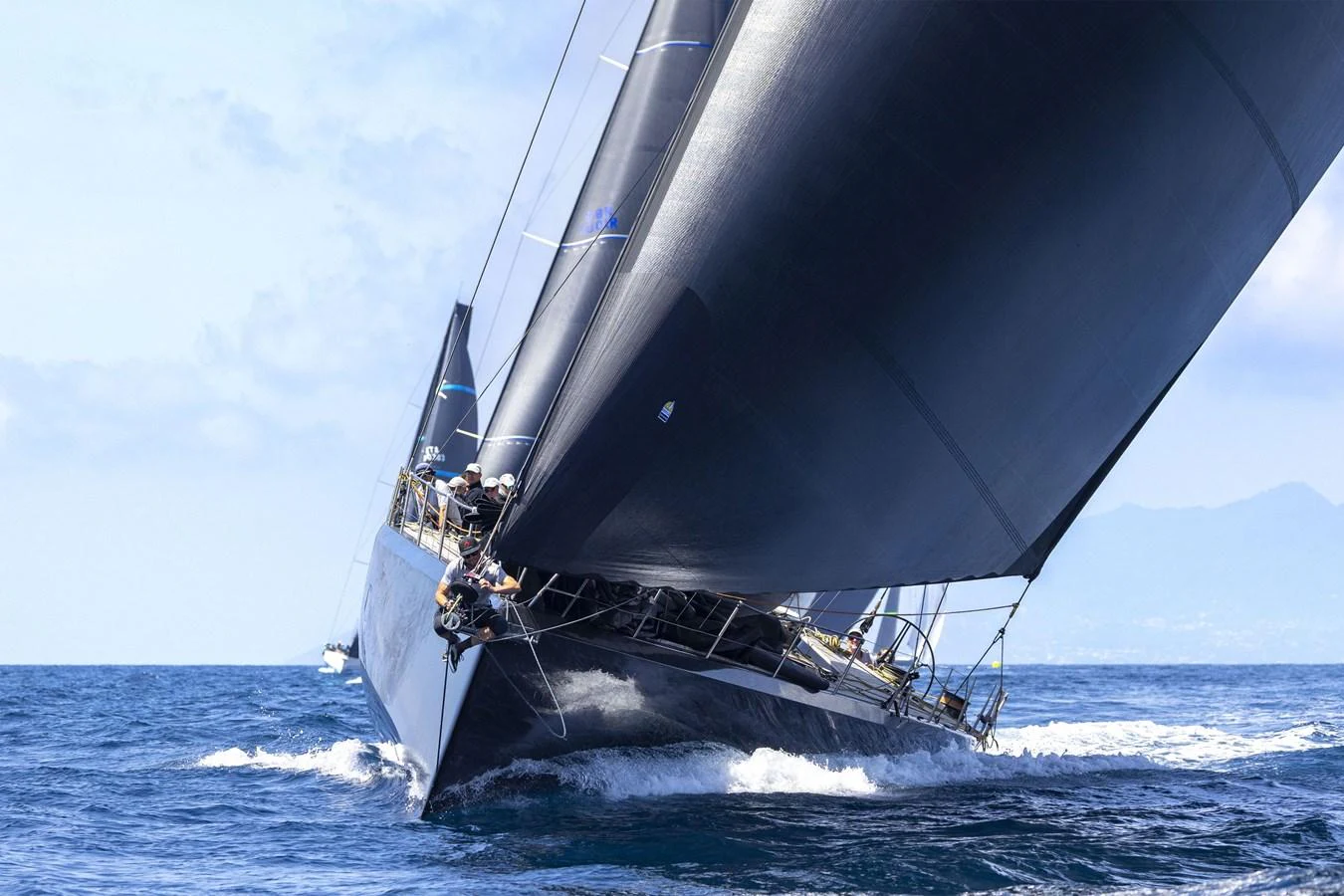 A sleek sailing yacht glides through the water with its sails fully extended. aboard BULLITT Yacht for Sale
