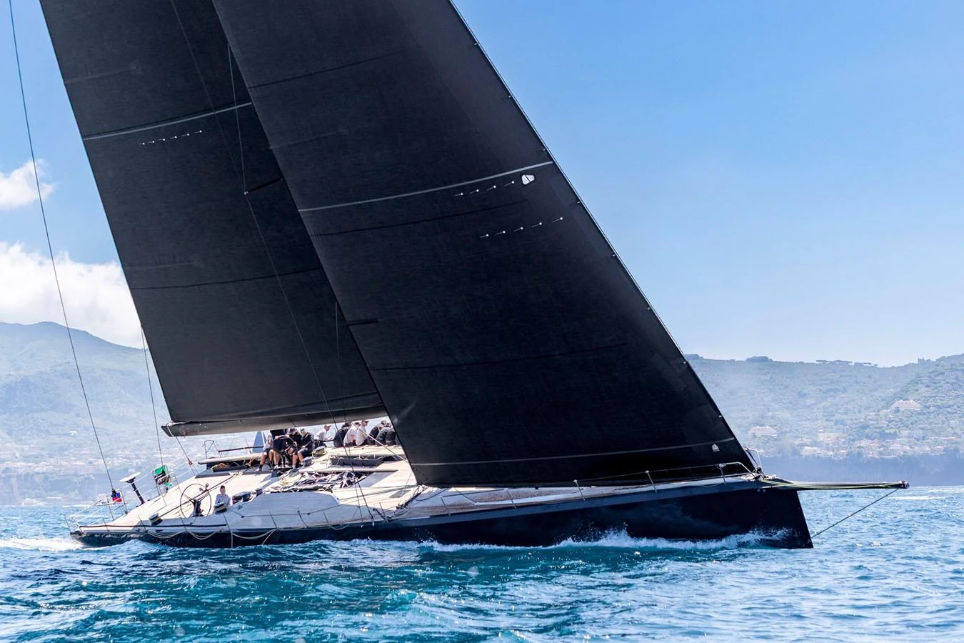 A sleek sailing yacht glides gracefully over the water with its sails fully extended. aboard BULLITT Yacht for Sale