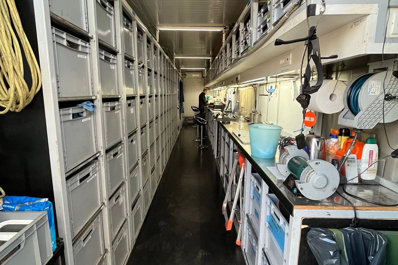 The image shows a well-organized storage area with numerous labeled bins and various equipment. aboard BULLITT Yacht for Sale