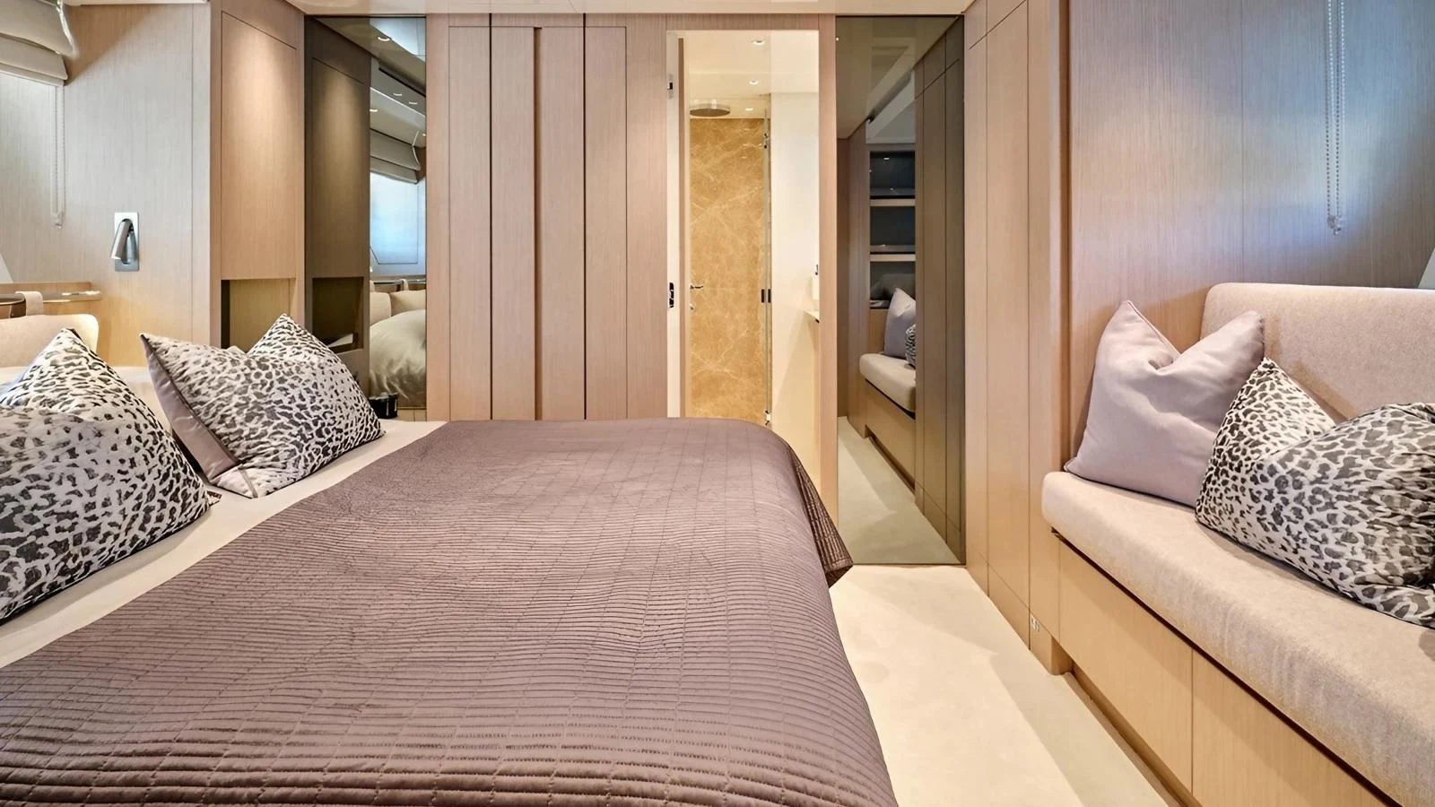 The master stateroom features a luxurious bed with plush pillows and ample storage space. aboard SAHASA I Yacht for Sale