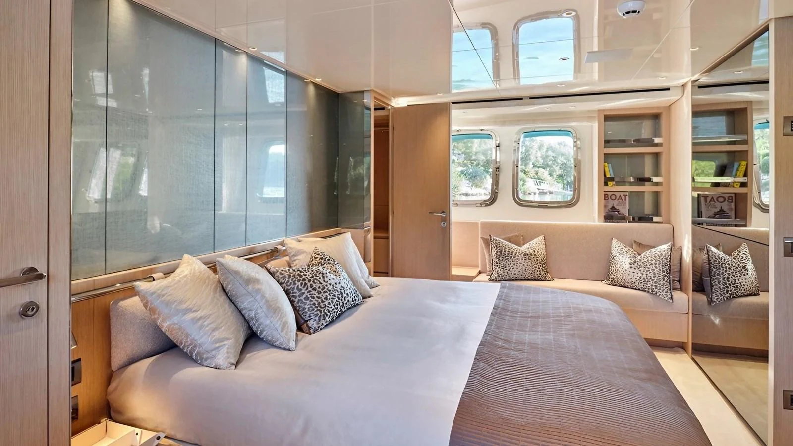 The master stateroom features a luxurious bed with ample natural light from large windows. aboard SAHASA I Yacht for Sale