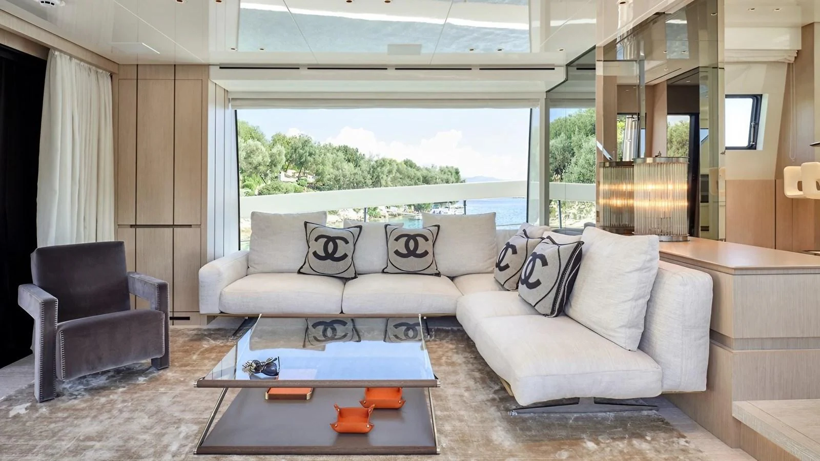 The salon features a spacious and elegant seating area with large windows offering scenic views. aboard SAHASA I Yacht for Sale