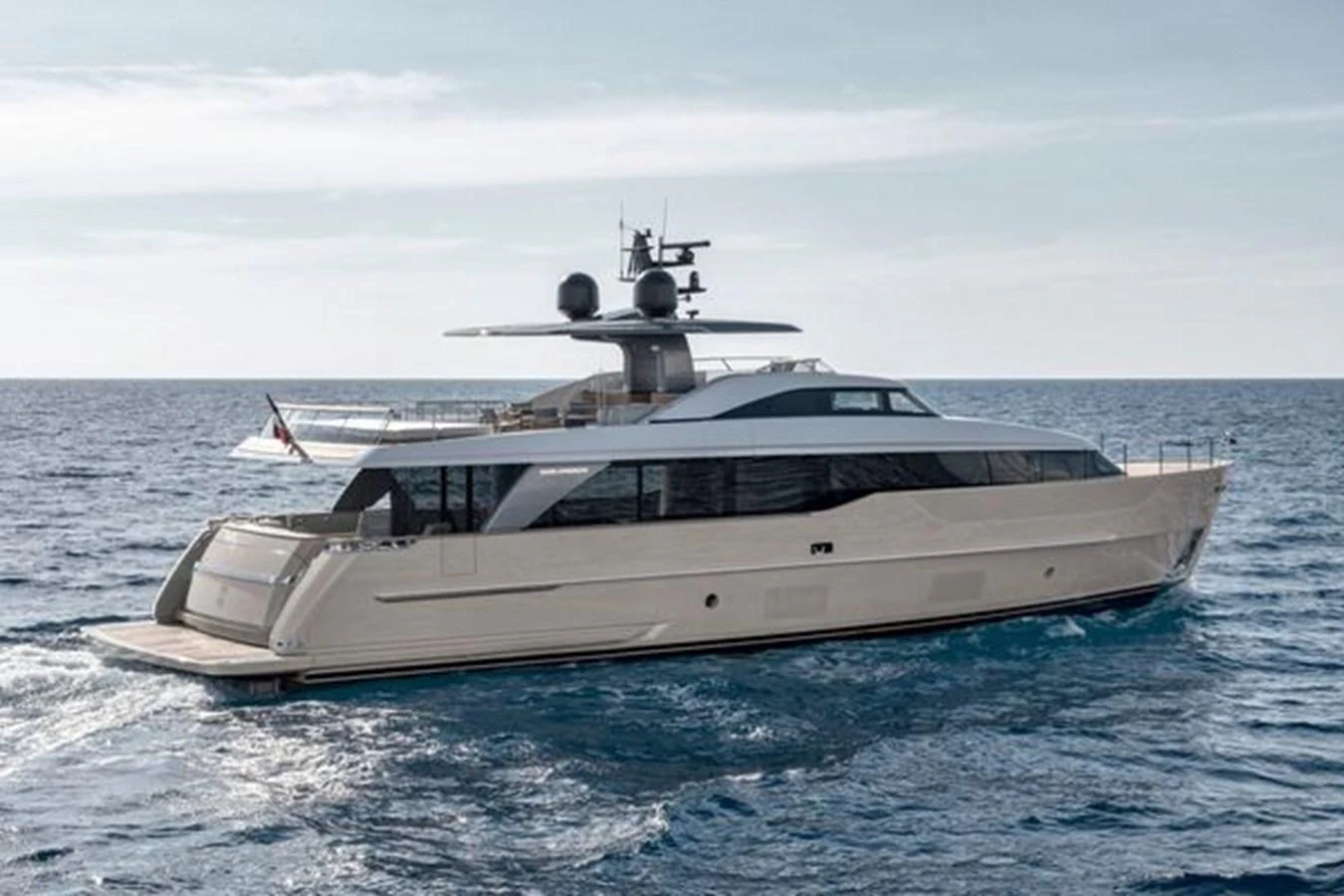 A sleek and modern yacht cruising on open waters under a clear sky. aboard 2025 SANLORENZO SD90 #180 Yacht for Sale