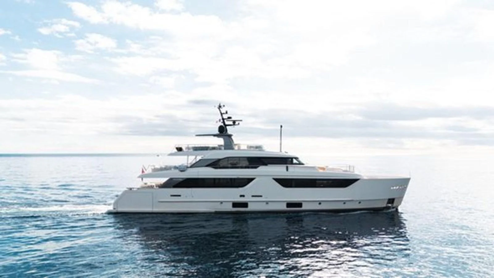 A sleek and modern yacht glides gracefully on calm waters under a bright sky. aboard 2022 SANLORENZO SD118 Yacht for Sale