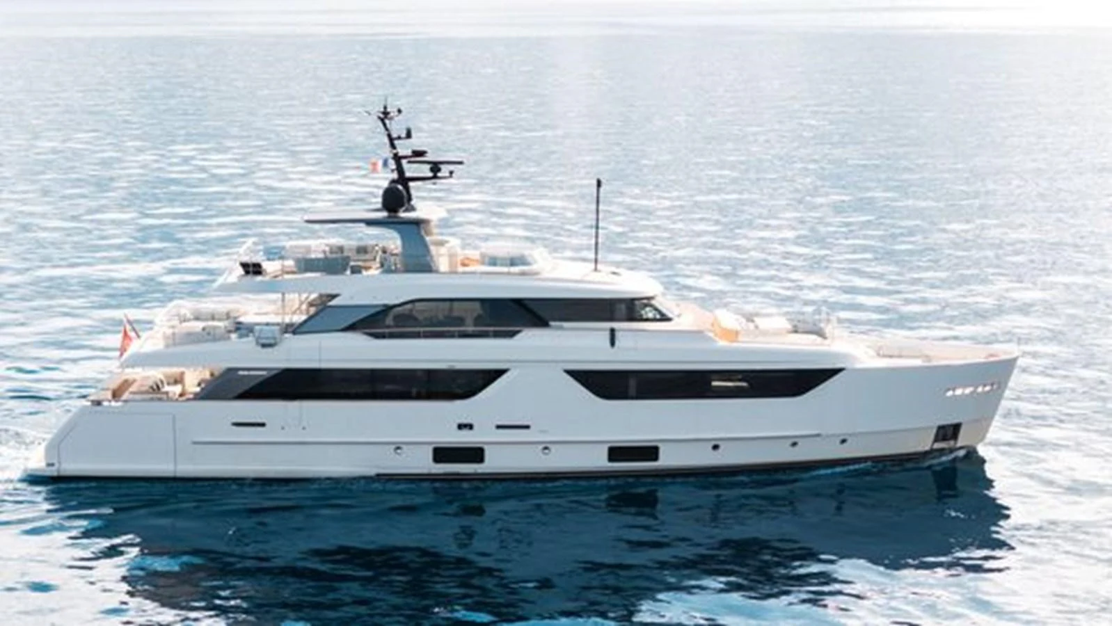A sleek and modern yacht glides gracefully on calm waters, showcasing its elegant design. aboard 2022 SANLORENZO SD118 Yacht for Sale