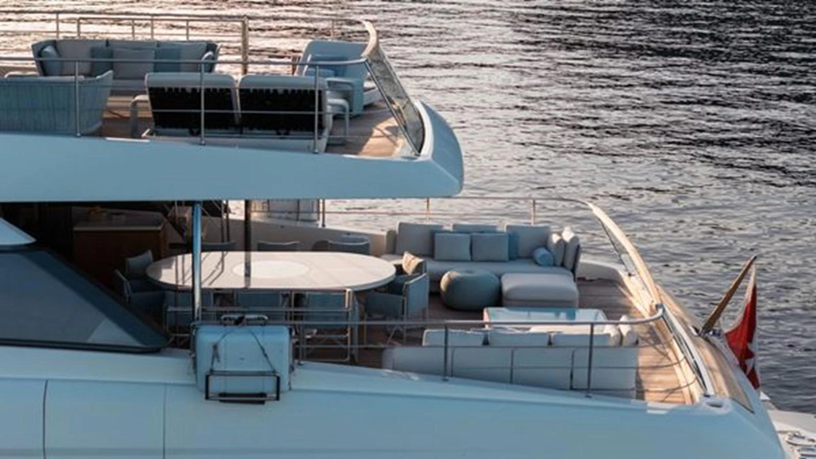 The yacht's aft deck features elegant outdoor seating and dining areas with a beautiful view of the water. aboard 2022 SANLORENZO SD118 Yacht for Sale