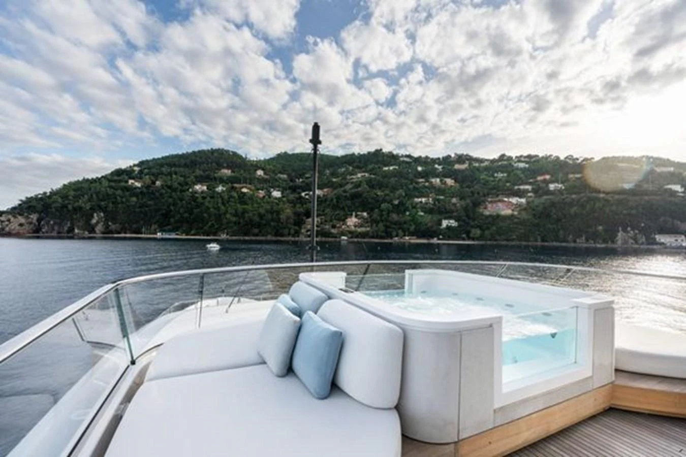 The sundeck features a luxurious jacuzzi with plush seating, offering stunning views of the surrounding landscape. aboard 2022 SANLORENZO SD118 Yacht for Sale
