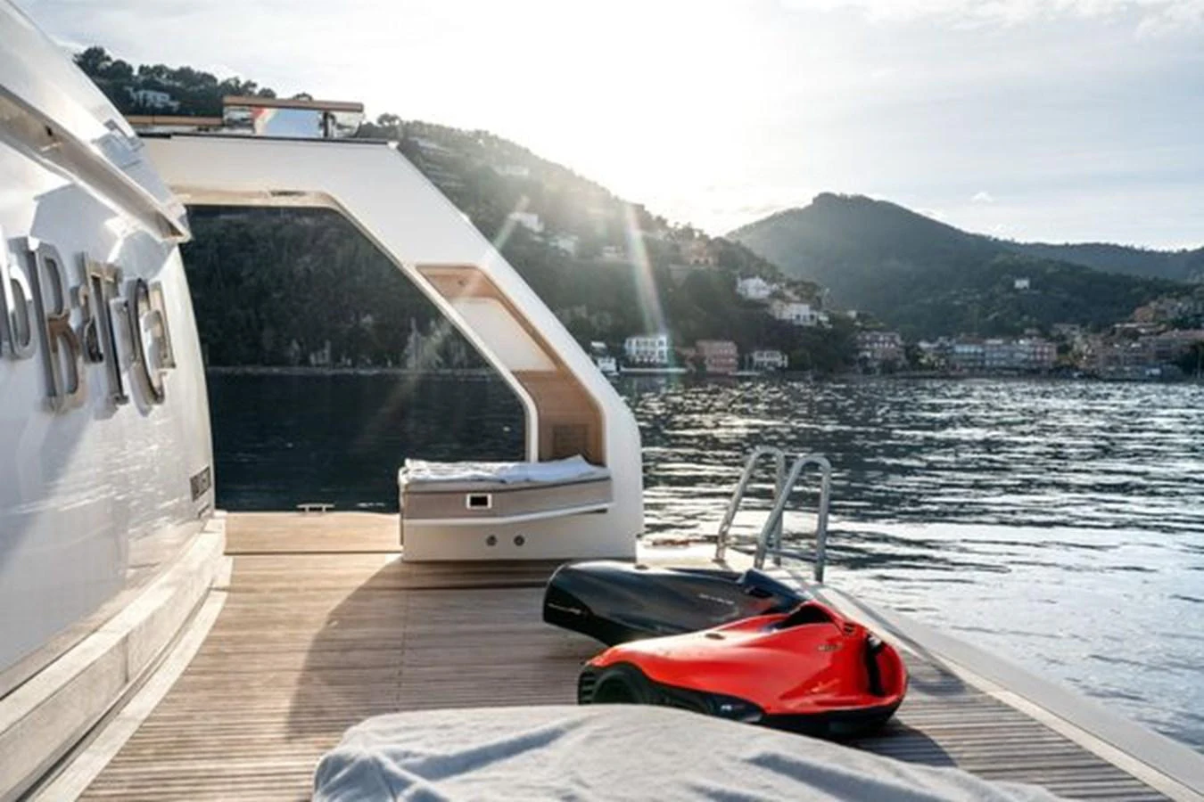 The aft deck offers a serene view of the water with comfortable seating and a sleek water toy. aboard 2022 SANLORENZO SD118 Yacht for Sale