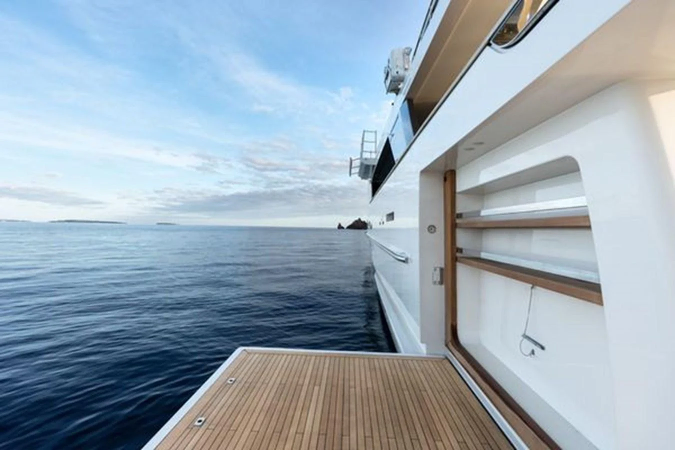 The yacht's aft deck offers a serene view of the open sea, perfect for relaxation. aboard 2022 SANLORENZO SD118 Yacht for Sale