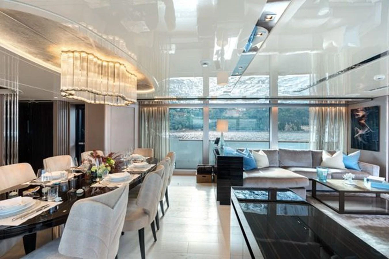 The salon features a spacious dining area and a comfortable seating arrangement with panoramic windows offering stunning views. aboard 2022 SANLORENZO SD118 Yacht for Sale