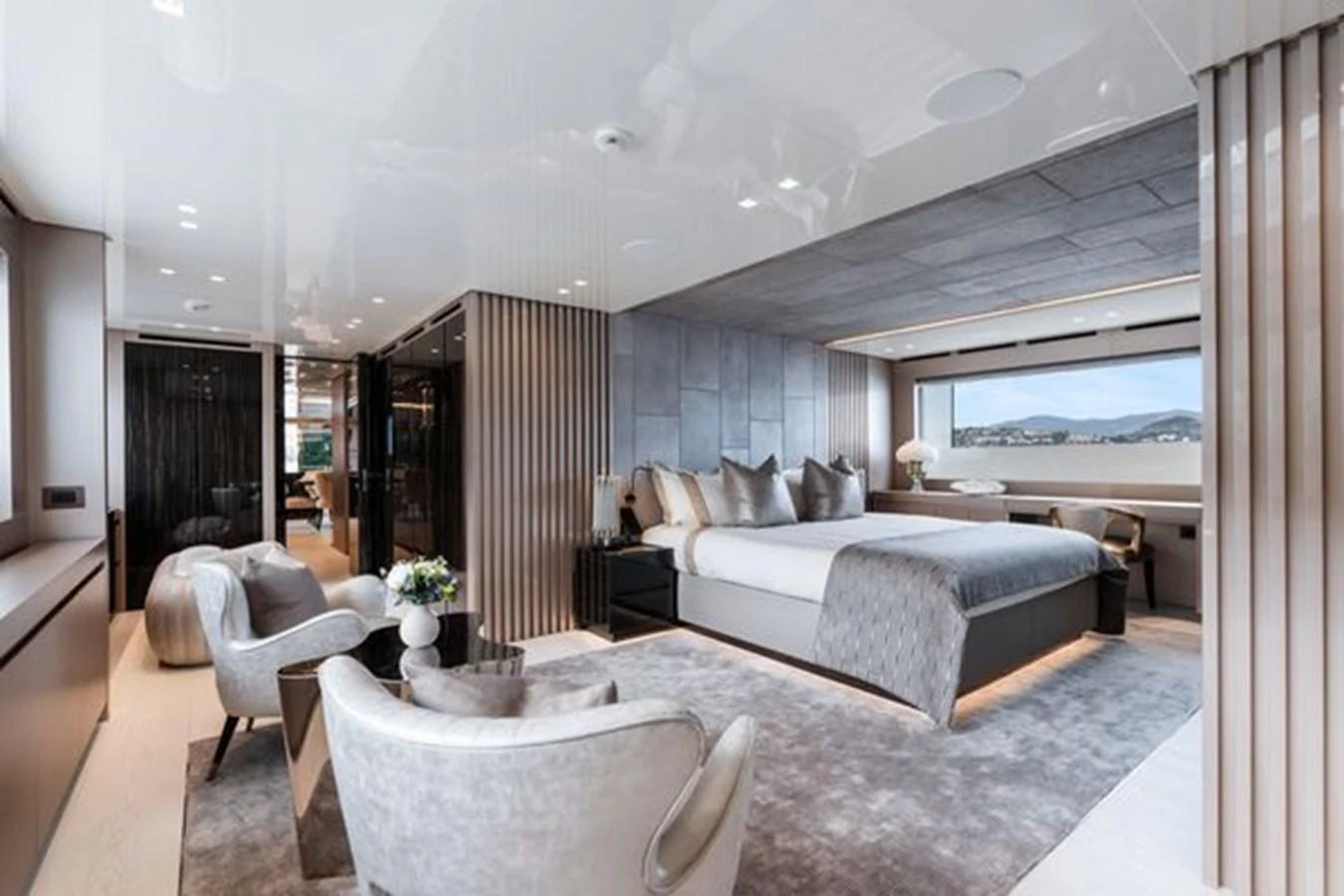 The master stateroom features a luxurious bed, elegant seating area, and large windows offering stunning views. aboard 2022 SANLORENZO SD118 Yacht for Sale