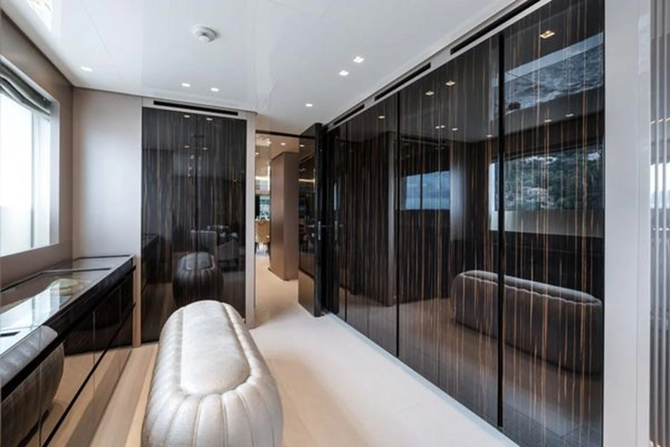 A luxurious yacht interior featuring sleek, dark wood paneling and plush seating. aboard 2022 SANLORENZO SD118 Yacht for Sale