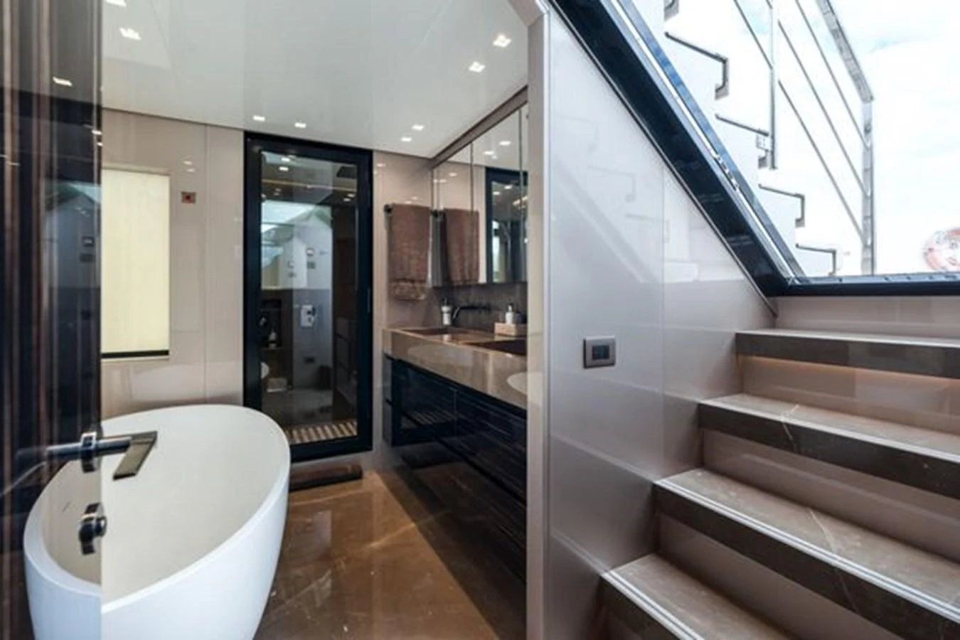 A luxurious yacht bathroom featuring a modern freestanding bathtub and elegant fixtures. aboard 2022 SANLORENZO SD118 Yacht for Sale