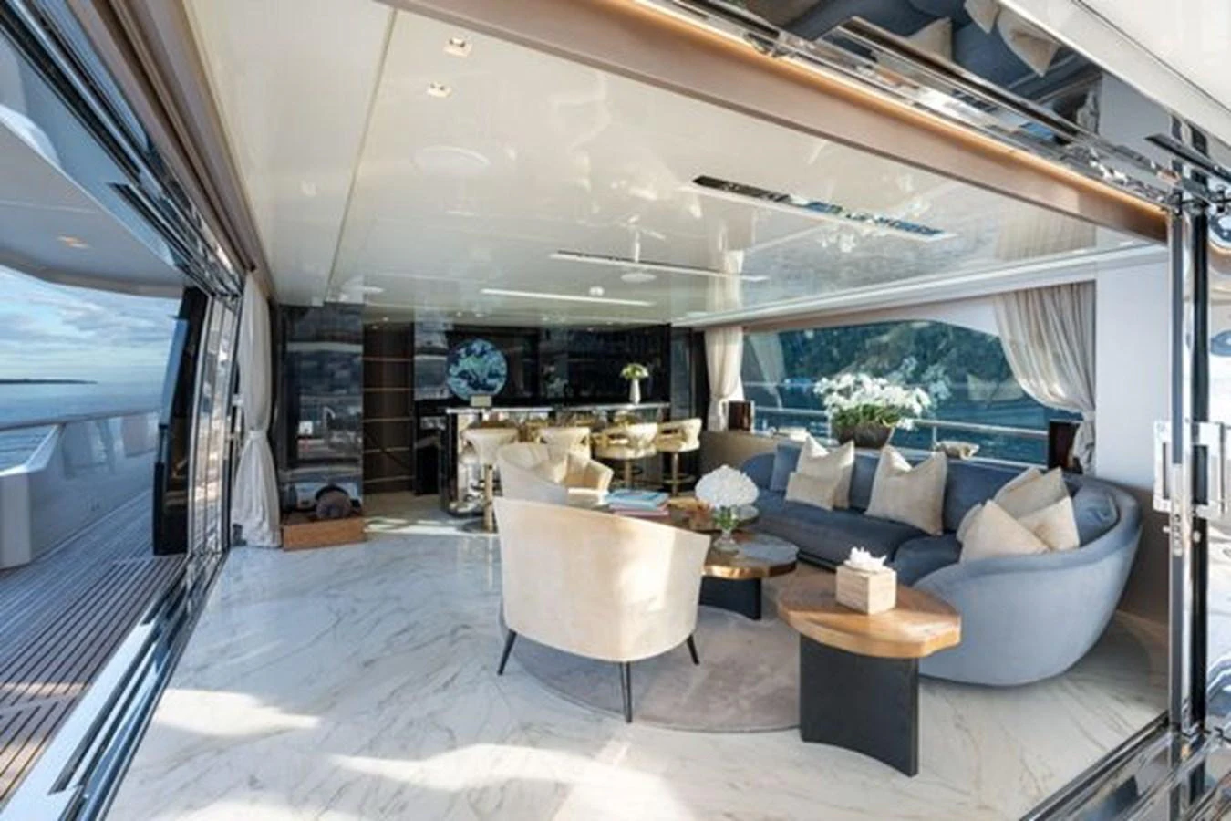 The yacht's salon features luxurious seating and elegant decor with expansive views. aboard 2022 SANLORENZO SD118 Yacht for Sale