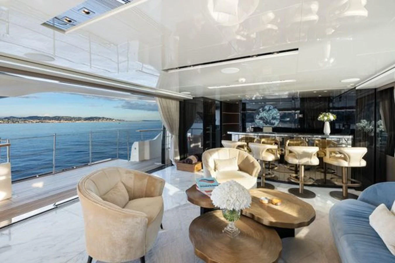 The salon offers a luxurious and spacious area with elegant seating and stunning ocean views. aboard 2022 SANLORENZO SD118 Yacht for Sale