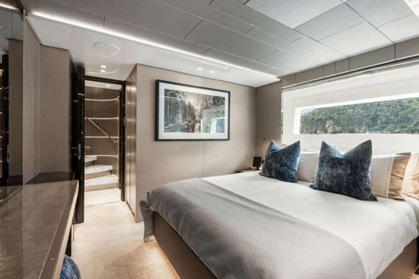 A luxurious stateroom featuring a large bed with plush pillows and modern decor. aboard 2022 SANLORENZO SD118 Yacht for Sale