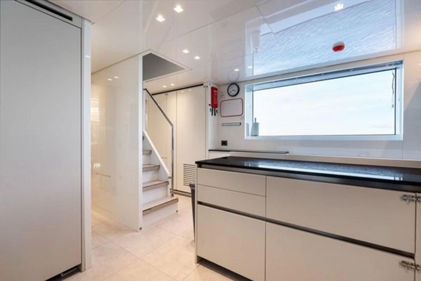 The galley features modern cabinetry, ample counter space, and a large window for natural light. aboard 2022 SANLORENZO SD118 Yacht for Sale