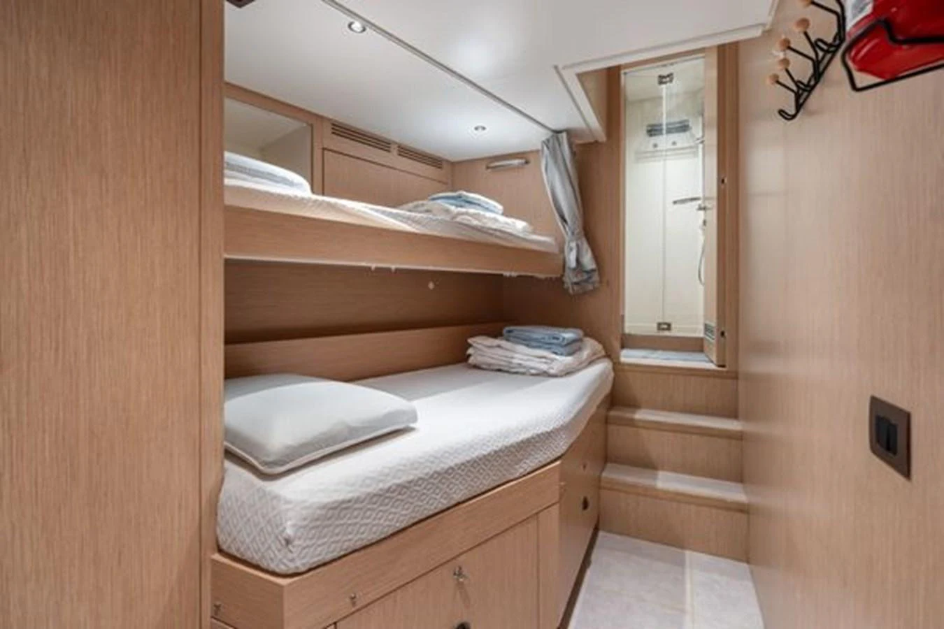 The guest cabin features cozy bunk beds with a private en-suite bathroom. aboard 2022 SANLORENZO SD118 Yacht for Sale