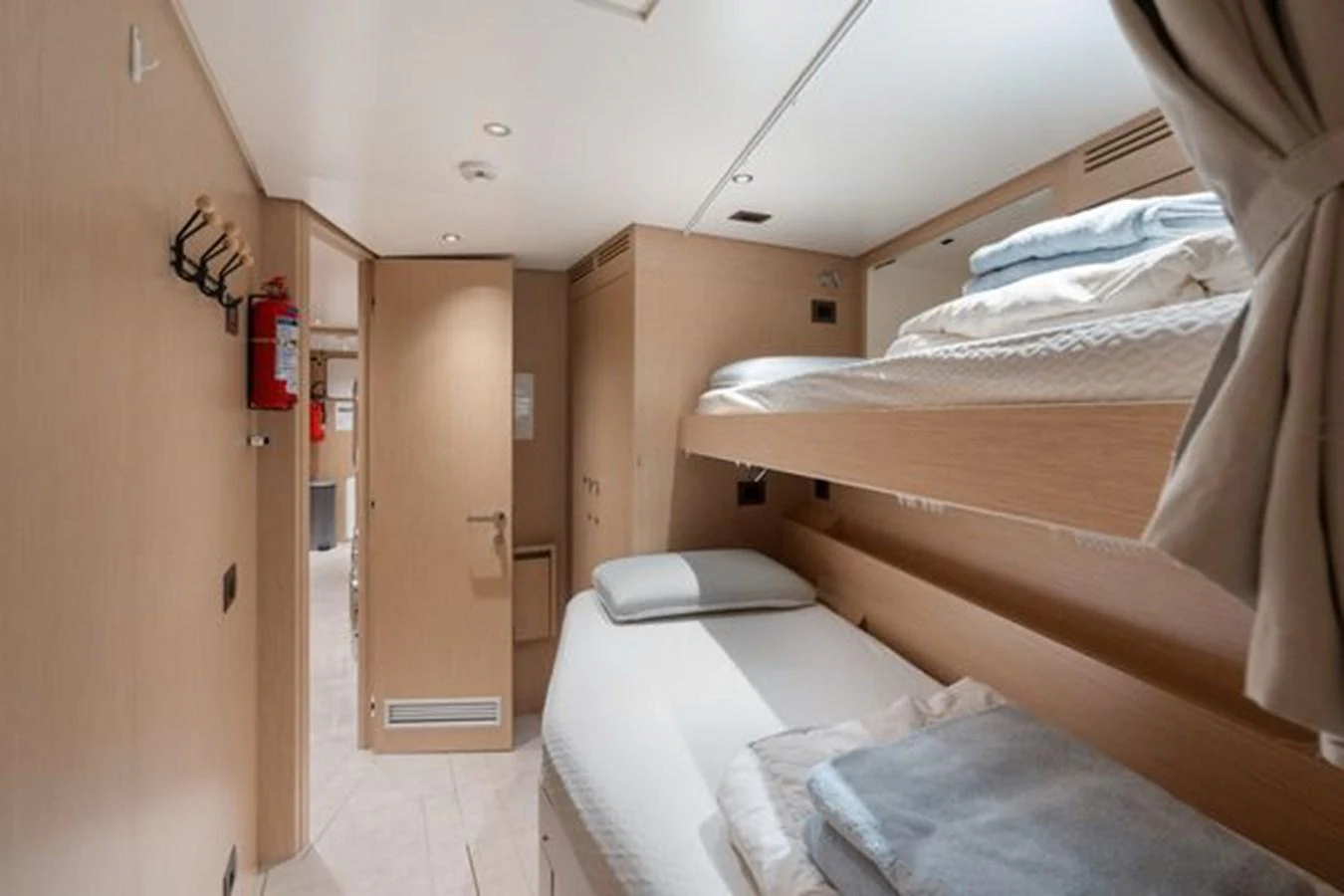 The crew quarters feature practical bunk beds and a minimalist design for efficient use of space. aboard 2022 SANLORENZO SD118 Yacht for Sale