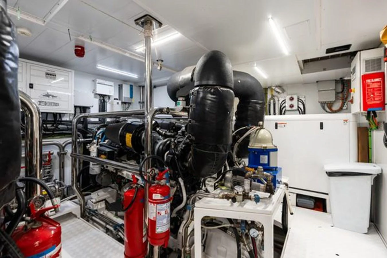 The image showcases the well-maintained engine room of the yacht, highlighting its mechanical systems and safety equipment. aboard 2022 SANLORENZO SD118 Yacht for Sale