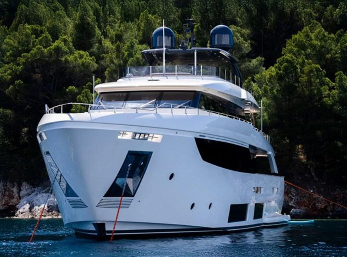 a white boat with a blue roof aboard SK Yacht for Sale