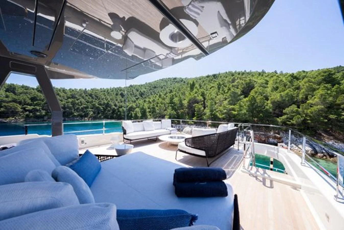 a pool with a deck and a view of the trees aboard SK Yacht for Sale