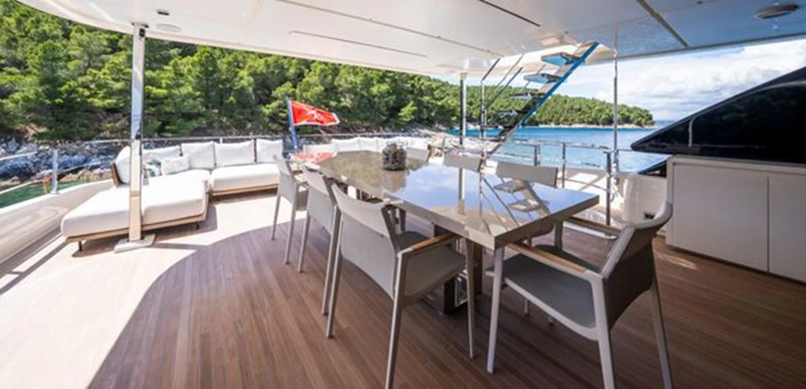 a table and chairs on a deck aboard SK Yacht for Sale