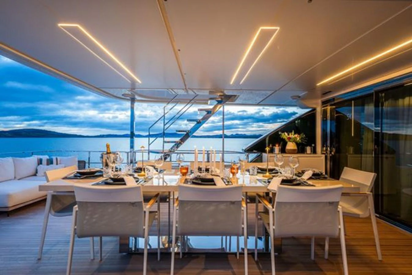 a large room with a large table and chairs aboard SK Yacht for Sale