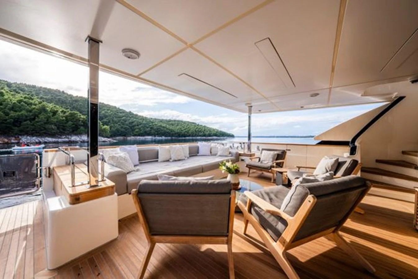 a room with a large bed and a table with chairs on it aboard SK Yacht for Sale