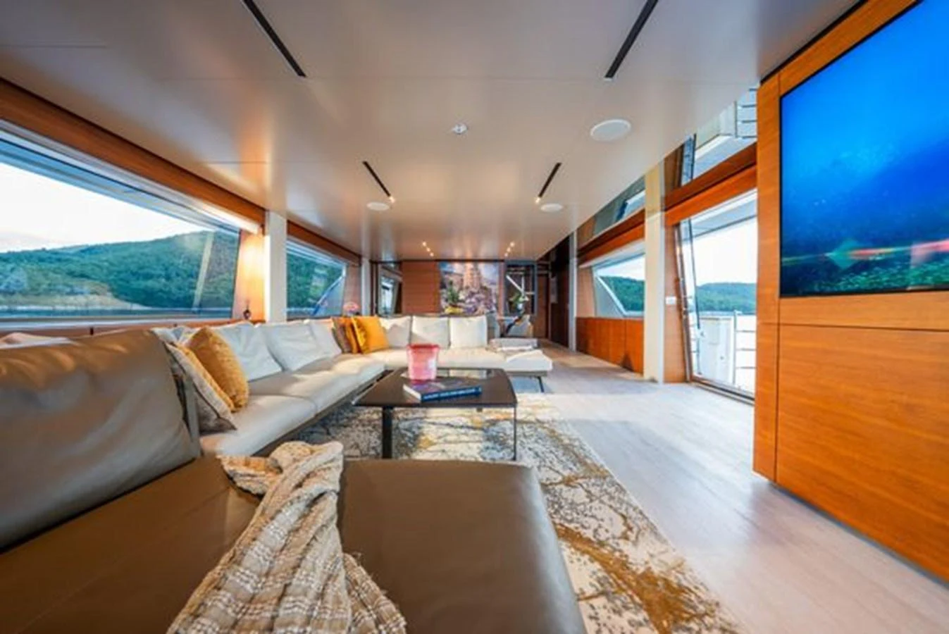 a living room with a large screen aboard SK Yacht for Sale