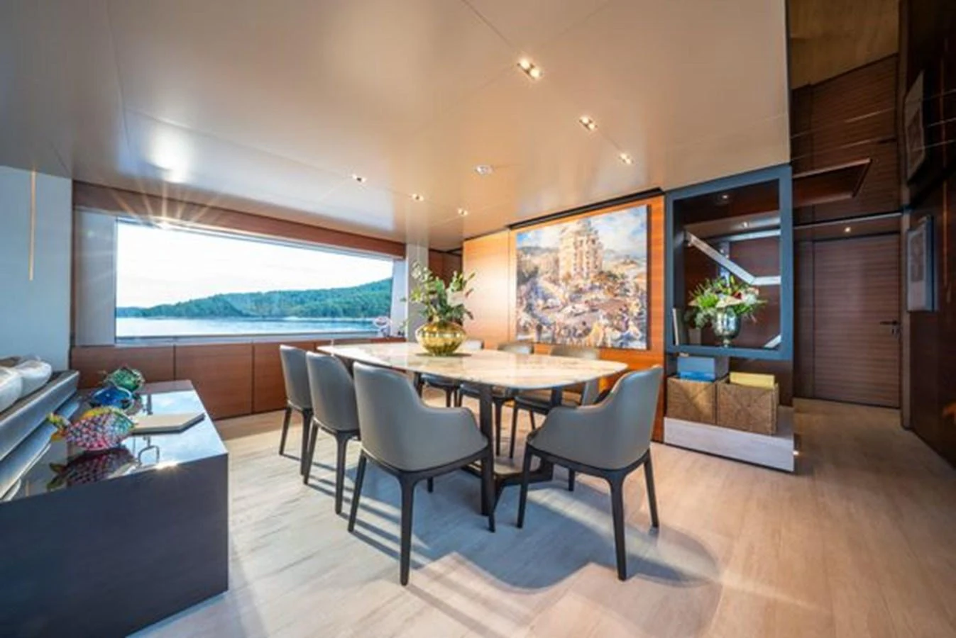 a room with a table chairs and a window aboard SK Yacht for Sale