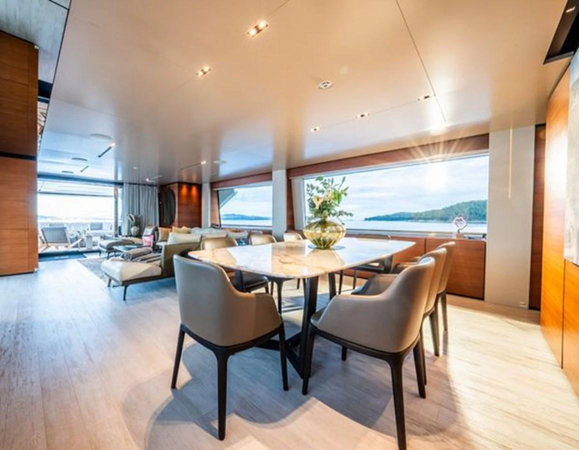 a large dining table in a room aboard SK Yacht for Sale