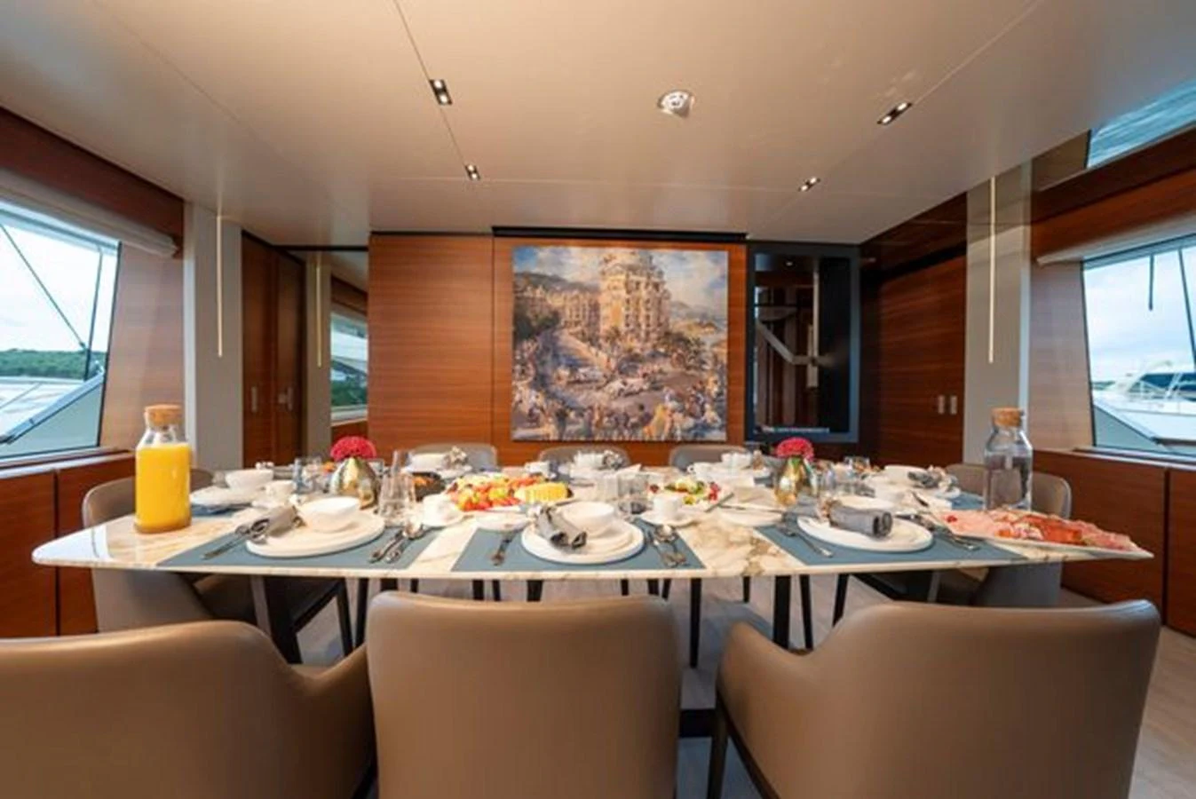 a dining table with plates and glasses aboard SK Yacht for Sale