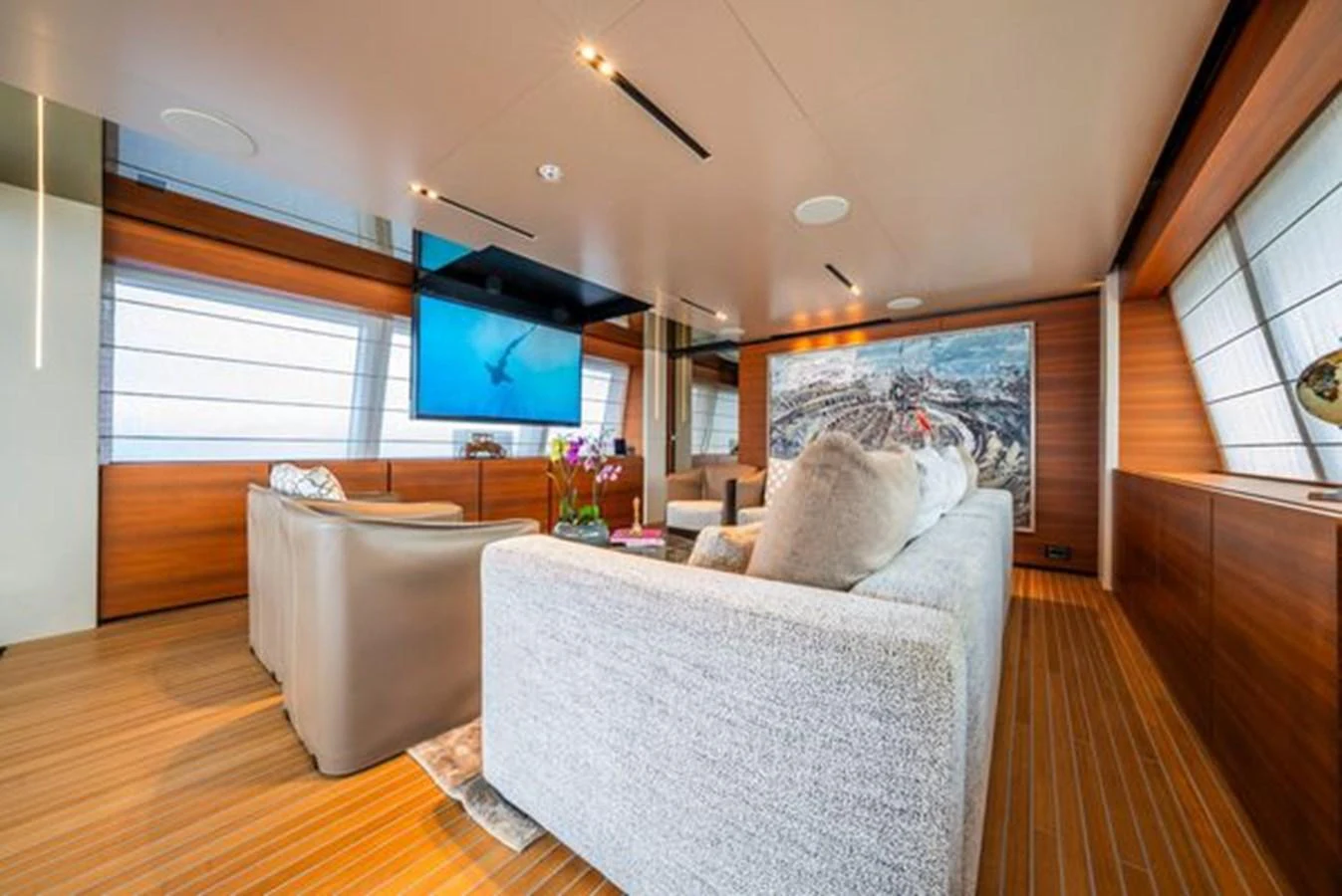 a living room with a large screen aboard SK Yacht for Sale