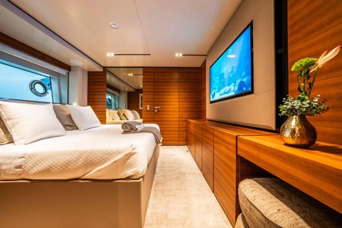 a room with a bed and a tv on the wall aboard SK Yacht for Sale