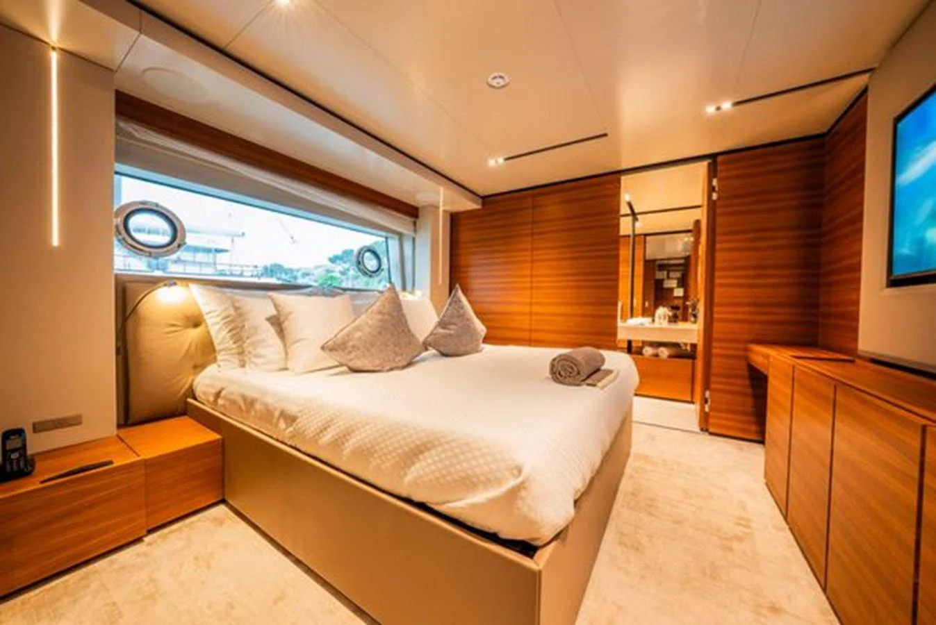 a bedroom with a bed and a tv aboard SK Yacht for Sale