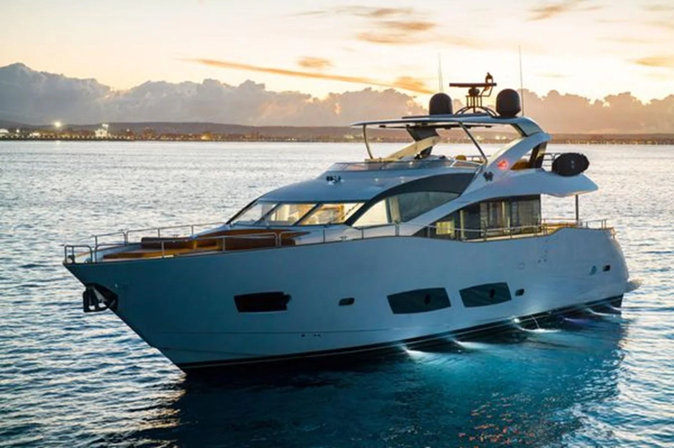 A sleek and modern yacht cruising at sunset with elegant lighting. aboard 2015 SUNSEEKER 28M RIII Yacht for Sale