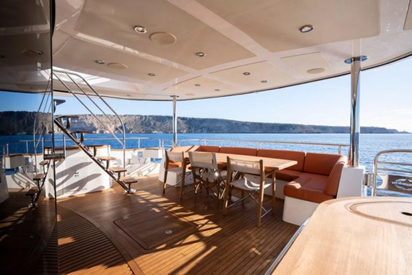 The aft deck features a spacious seating area with a dining table, perfect for enjoying meals with a view of the sea. aboard 2015 SUNSEEKER 28M RIII Yacht for Sale