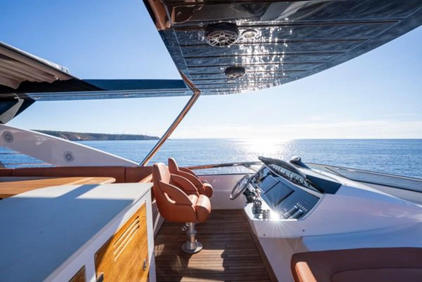 The helm area offers a stunning view of the open sea with luxurious seating and advanced navigation equipment. aboard 2015 SUNSEEKER 28M RIII Yacht for Sale